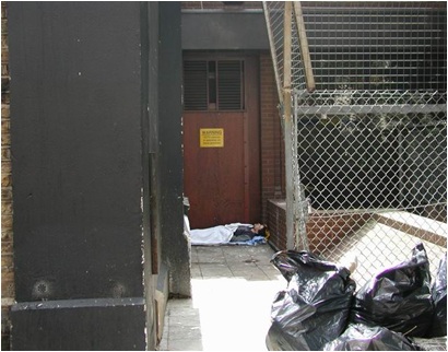 Commercial building's recessed door blocked by rough sleeper